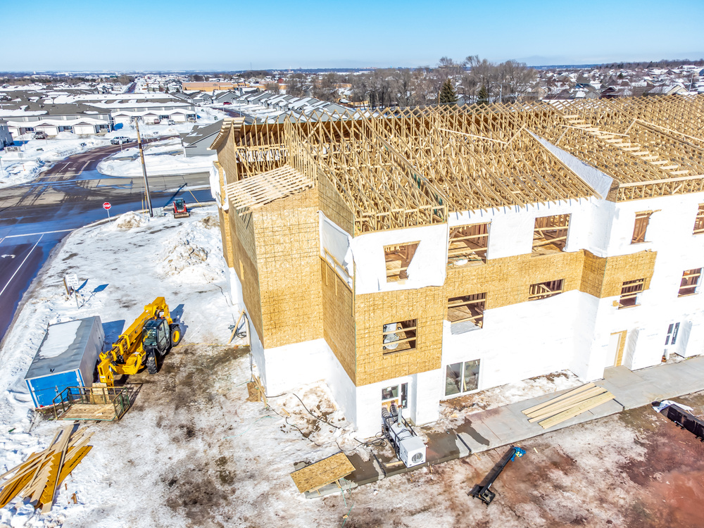 Aerial drone view of a multifamily apartment complex under construction.